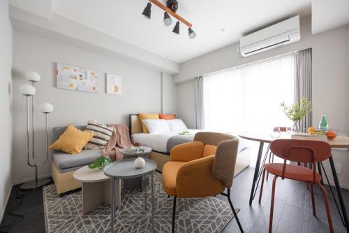 a living room with a couch and a table at PREAS Nakano Arai in Tokyo
