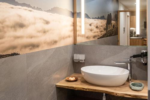 a bathroom with a white bowl sink on a wooden counter at Parndlehof in Villandro