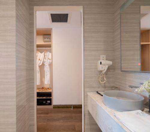a bathroom with a sink and a mirror at Lucky Sun Hotel Nha Trang Beach in Nha Trang