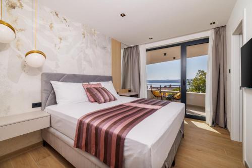 a bedroom with a large bed and a large window at Villa Vista Maris in Crikvenica