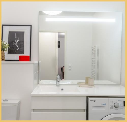 a white bathroom with a sink and a mirror at Le 1848 I T2 I Cluses in Cluses