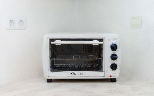 a white toaster oven sitting in a room at Ombe Villa in Labuan Lombok