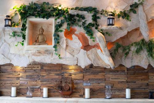 a wall with a painting of a buddha at Ombe Villa in Labuan Lombok