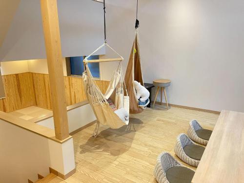 a room with several hanging hammocks in a room at Rakuten STAY VILLA Kinugawa Riverside in Nikko