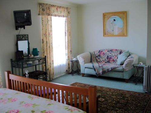 a living room with a bed and a couch at The Linear Way Bed and Breakfast in McLaren Vale