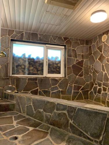 a room with a stone wall and a window at Yotei no Sato in Niseko