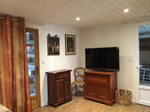 un salon avec une télévision à écran plat sur un meuble dans l'établissement Agréable logement, à Ginestet