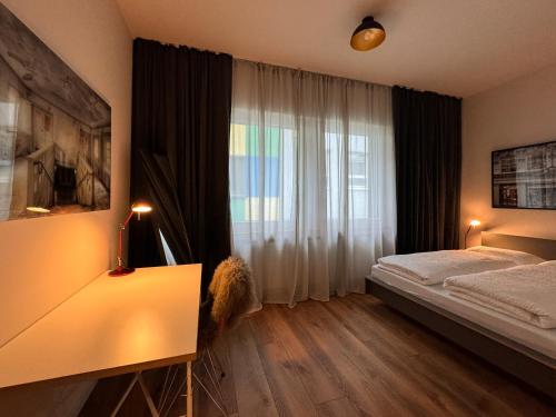 a bedroom with a bed and a large window at Luxusapartment, Kornmarkt, Stadtmitte, Zentral in Essen