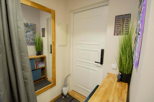 a white door in a room with some plants at KarlovaIdyll 7 - Homey Apartment with FREE Parking! in Tartu