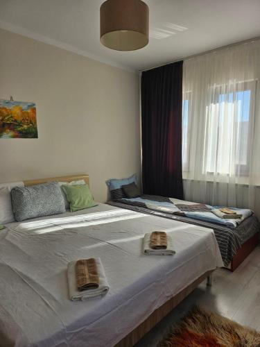 a bedroom with two beds with towels on them at Бадевски рай-къща Вяра in Badewzi