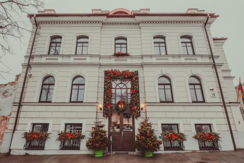 a white building with christmas decorations on it at Moon Garden Old Town Hotel in Vilnius