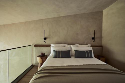 a bedroom with a large bed with two pillows at Zelia Halkidiki, part of Destination by Hyatt - Adults Only in Nea Potidaea