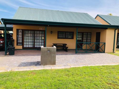 a small house with a picnic table in front of it at Pendleberry Grove Unit 8 in Bela-Bela
