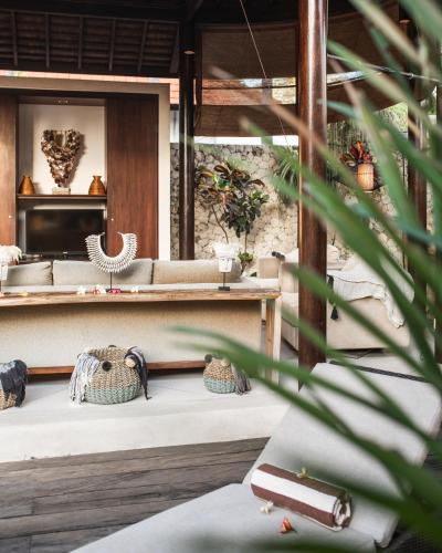 a view of a room with a table and a couch at Sandi Kala Villas in Kerobokan