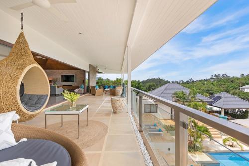 an outdoor balcony with a view of a villa at Here and Now - Luxury Sea view & Spa Villa in Koh Samui 