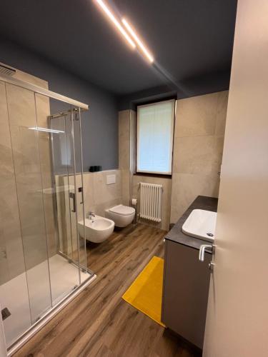 a bathroom with a shower and a sink and a toilet at NEW Luxury Apartment - Menaggio in Menaggio