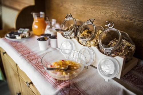 a buffet with a bowl of food on a table at Pension Pcei in Picciai