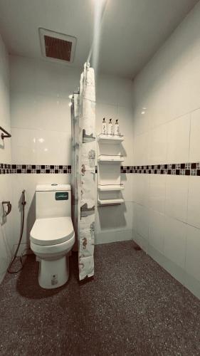 a bathroom with a white toilet in a room at Modern House near Don Muang Airport, near SRT Rangsit & Future Park Rangsit in Ban Talat Rangsit