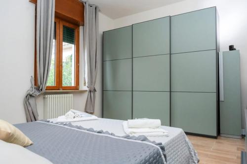 a bedroom with two beds and a large glass wall at Bonsai B&B in Verona