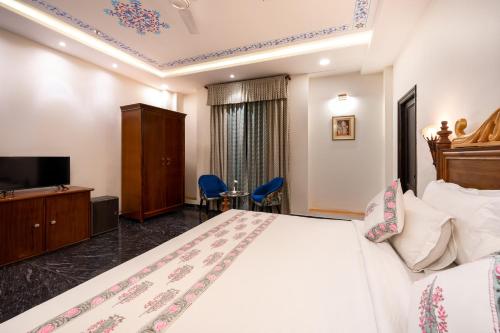 a hotel room with a bed and a television at The Chronicles - Near the Lake Pichola Udaipur in Udaipur