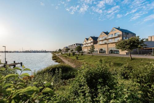 eine Häuserreihe neben einem Gewässer in der Unterkunft Apartments Rooftop Garden 5 -7 im Ostseeresort Olpenitz in Olpenitz