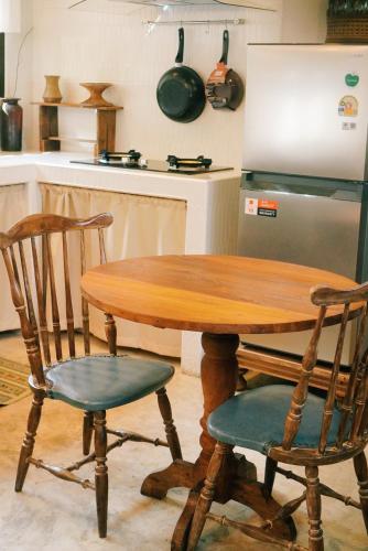 a wooden table and two chairs in a kitchen at Foresta Villa in Hang Dong
