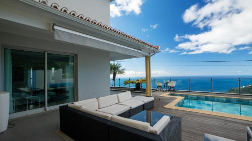 a living room with a view of the ocean at Estrela do Mar - by LovelyStay - Lovely, Sun Filled Villa in Calheta