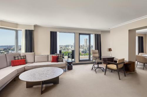 a living room with a couch and a table at Sheraton Grand Sydney Hyde Park in Sydney