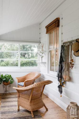 a room with wicker chairs and a window at Highland Cottage- Modern Country Life at Leura in Leura