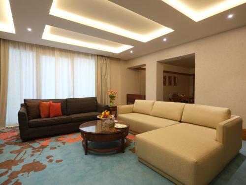 a living room with two couches and a table at Holiday Inn Kuwait Al Thuraya City by IHG in Kuwait