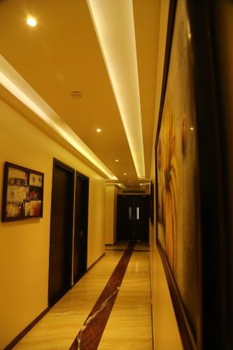 a hallway with a painting on the wall at The Golden Apple in Lucknow