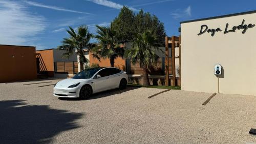 a white car parked in front of a building at DAYA LODGE. in LʼIsle-sur-la-Sorgue