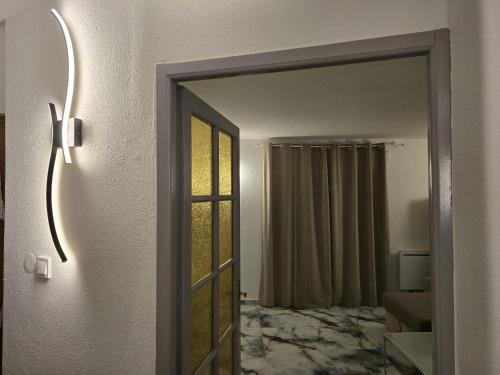 a door leading into a room with a mirror at Les Hirondelles in Andolsheim