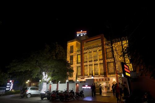 a building with a sign on top of it at night at The Golden Apple in Lucknow