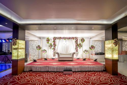 a room with a large bed with a red carpet at The Golden Apple in Lucknow