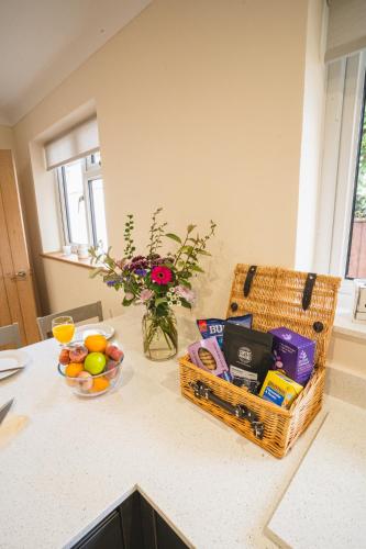 a kitchen counter with baskets of food and a vase of flowers at Little Hill Farm Villa in Ringwood