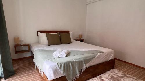 a bedroom with a bed with two towels on it at De Hope Kohlanta in Ko Lanta Yai
