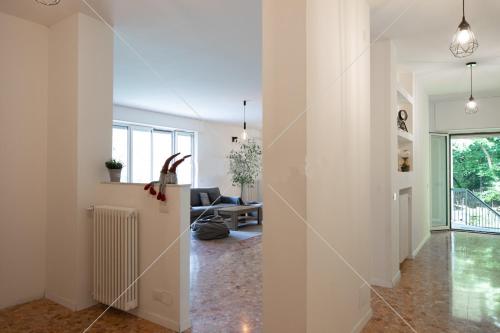 a hallway of a home with white walls and a living room at SleepWell in Valganna in Valganna