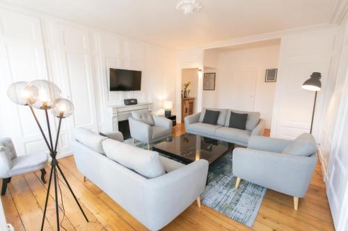 un salon avec deux canapés et une télévision dans l'établissement Appartement Haussmannien Centre Ville, à Besançon
