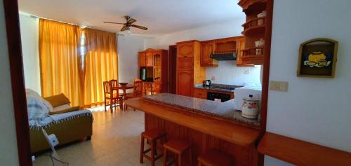 a kitchen with a counter top and a living room at Puerto Naos Beach 2 in Puerto Naos