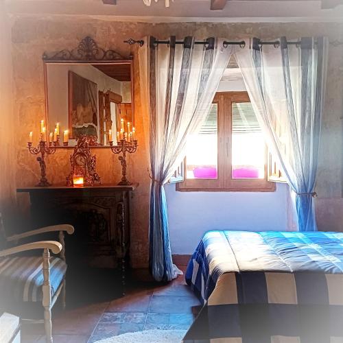 a bedroom with a bed and a window and a mirror at Casa rural en Buendía -la Galera con 4 dormitorios in Buendía