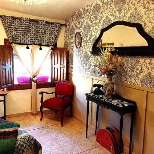 a room with a table and a chair and a window at Casa rural en Buendía -la Galera con 4 dormitorios in Buendía
