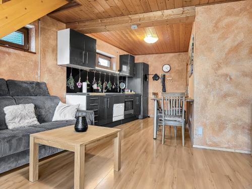 a living room with a couch and a table and a kitchen at Apartment Joelle mit Sauna, Schwimmteich und Gym in Erbach im Odenwald