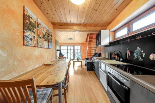 a kitchen with a wooden table and a counter at Apartment Joelle mit Sauna, Schwimmteich und Gym in Erbach im Odenwald