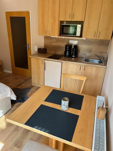 a small kitchen with a table and a counter top at Apartmány Gryf Harrachov in Harrachov