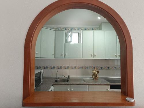 an archway in a kitchen with a sink and cabinets at Bahia de Vera apartamento Abaco in Playas de Vera