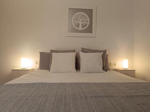 a bedroom with a bed with two lamps on tables at Bahia de Vera apartamento Abaco in Playas de Vera