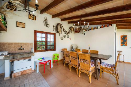 a kitchen with a table and chairs in a room at Can Bleo in Pollença