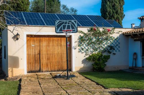 a house with a basketball hoop in front of a garage at Can Bleo in Pollença
