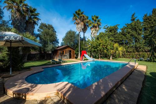 a swimming pool with a slide in a yard at Can Bleo in Pollença